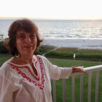 Jeri Diehl-Cusack stands in front of the water.