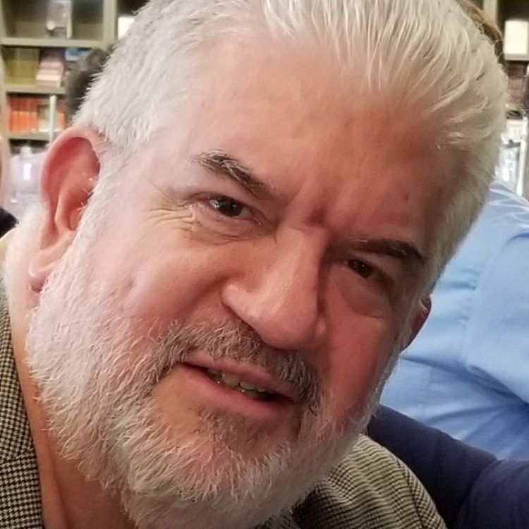 Close up of Eric Miller, a white man with white hair and beard.