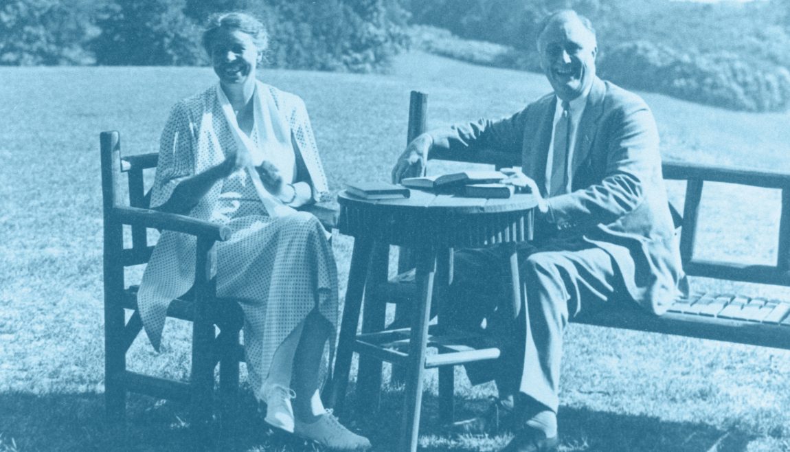 Franklin and Eleanor Roosevelt outside with a table of books