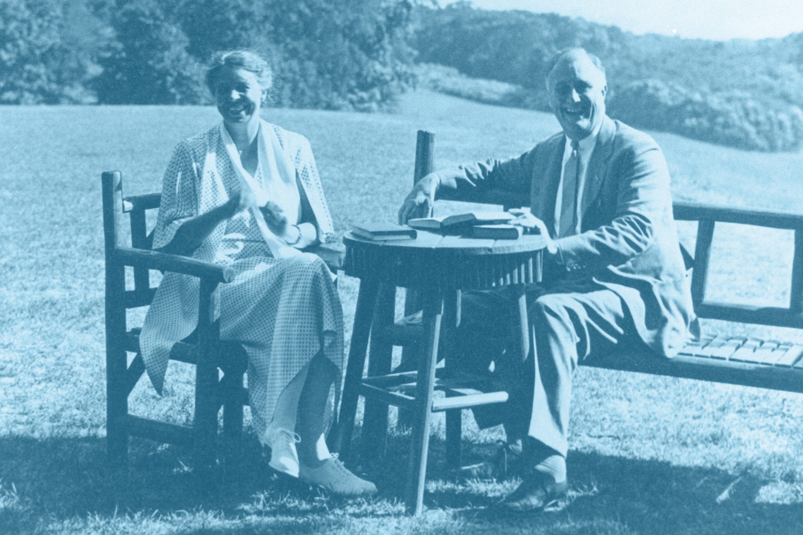 Franklin and Eleanor Roosevelt outside with a table of books