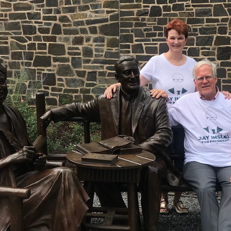 Image of Patrick and Susan Dunn sitting with the Eleanor and Franklin Roosevelt bench statue at the FRD Library