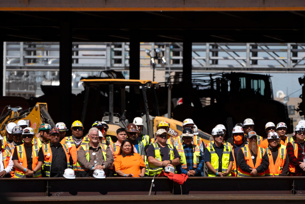 CHANDLER, ARIZONA - MARCH 20: Construction workers listen to a speech from US President Joe Biden at Intel Ocotillo Campus on March 20, 2024 in Chandler, Arizona. Biden announced $8.5 billion in federal funding from the CHIPS Act for Intel Corp. to manufacture semiconductors in Arizona. (Photo by Rebecca Noble/Getty Images)