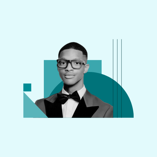 A person in a suit and bow tie, wearing glasses, is shown in a black and white portrait with geometric teal shapes in the background on a light blue backdrop.