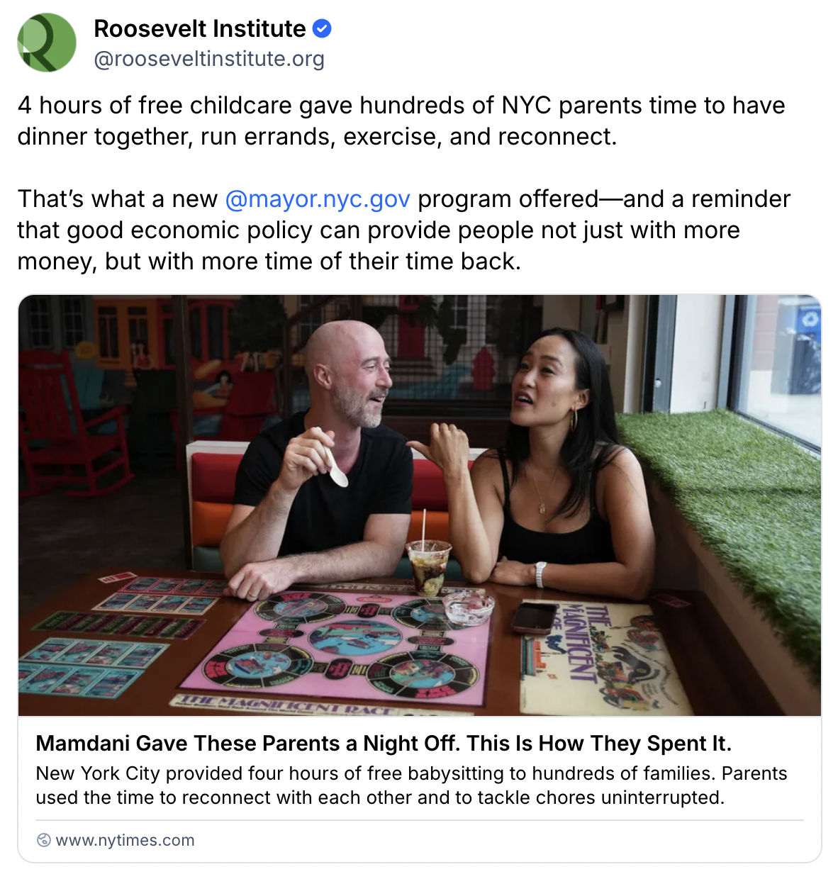 Two parents sit at a colorful table, smiling and talking, enjoying a meal together at a restaurant. Board games and plates are on the table, suggesting a relaxed, joyful night out.